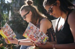 two women reading outside